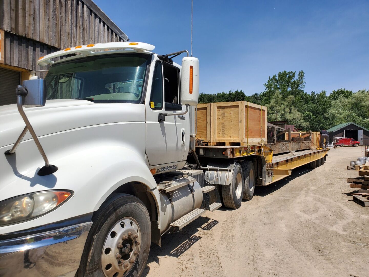 A flatbed truck with a crate